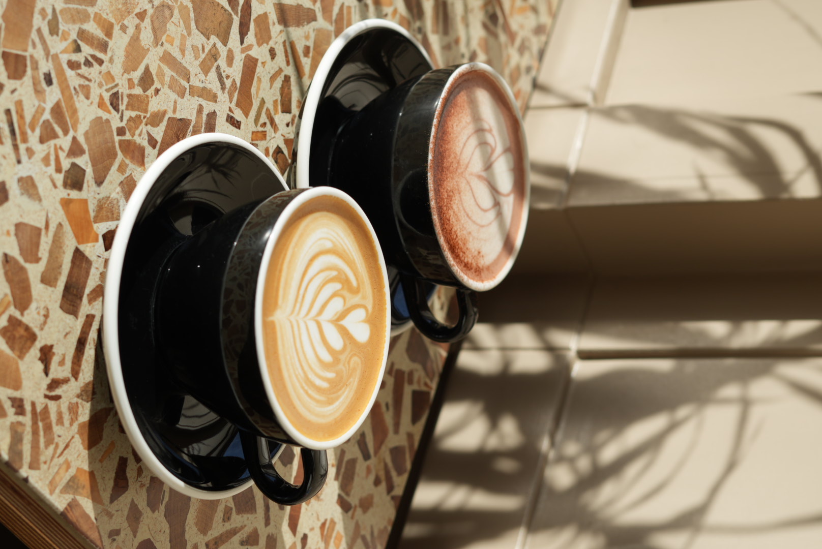Hot chocolate behind a flat white