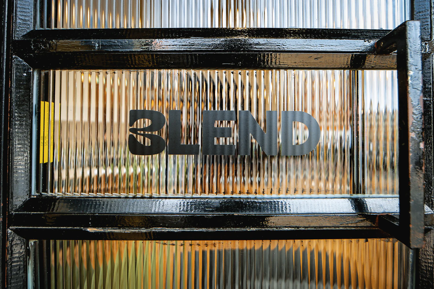 The BLEND logo etched on the reeded-glass front door