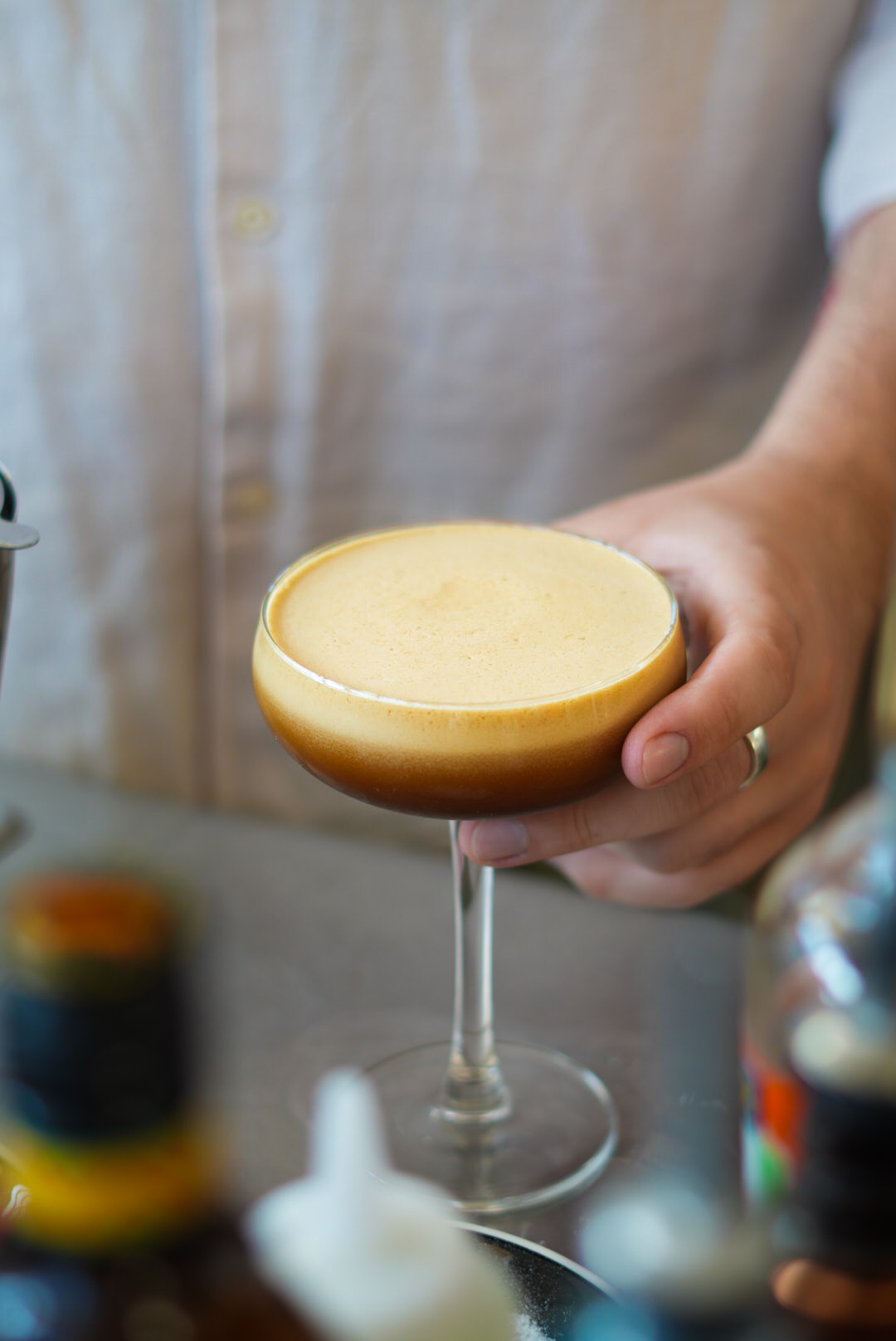 Espresso martini being handed across the bar