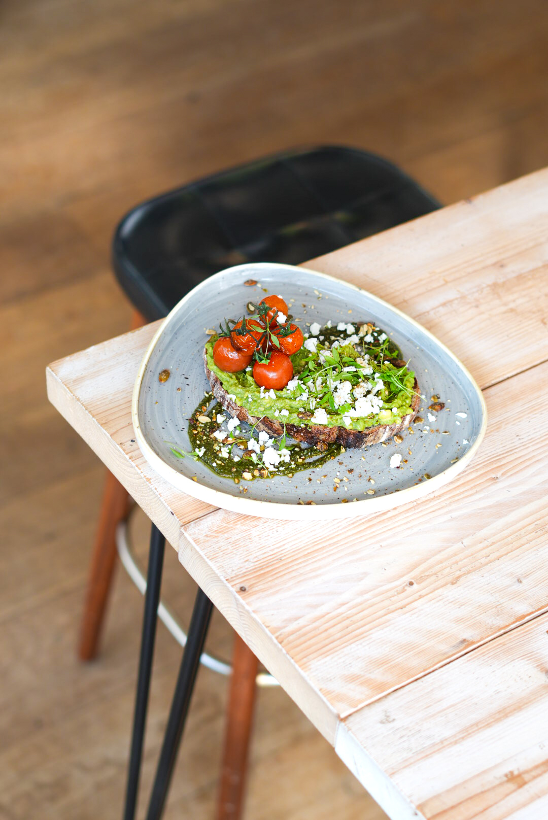 Avocado on sourdough with feta and blistered tomato